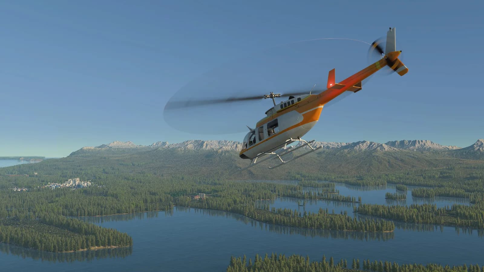Helicopter above lake and mountains