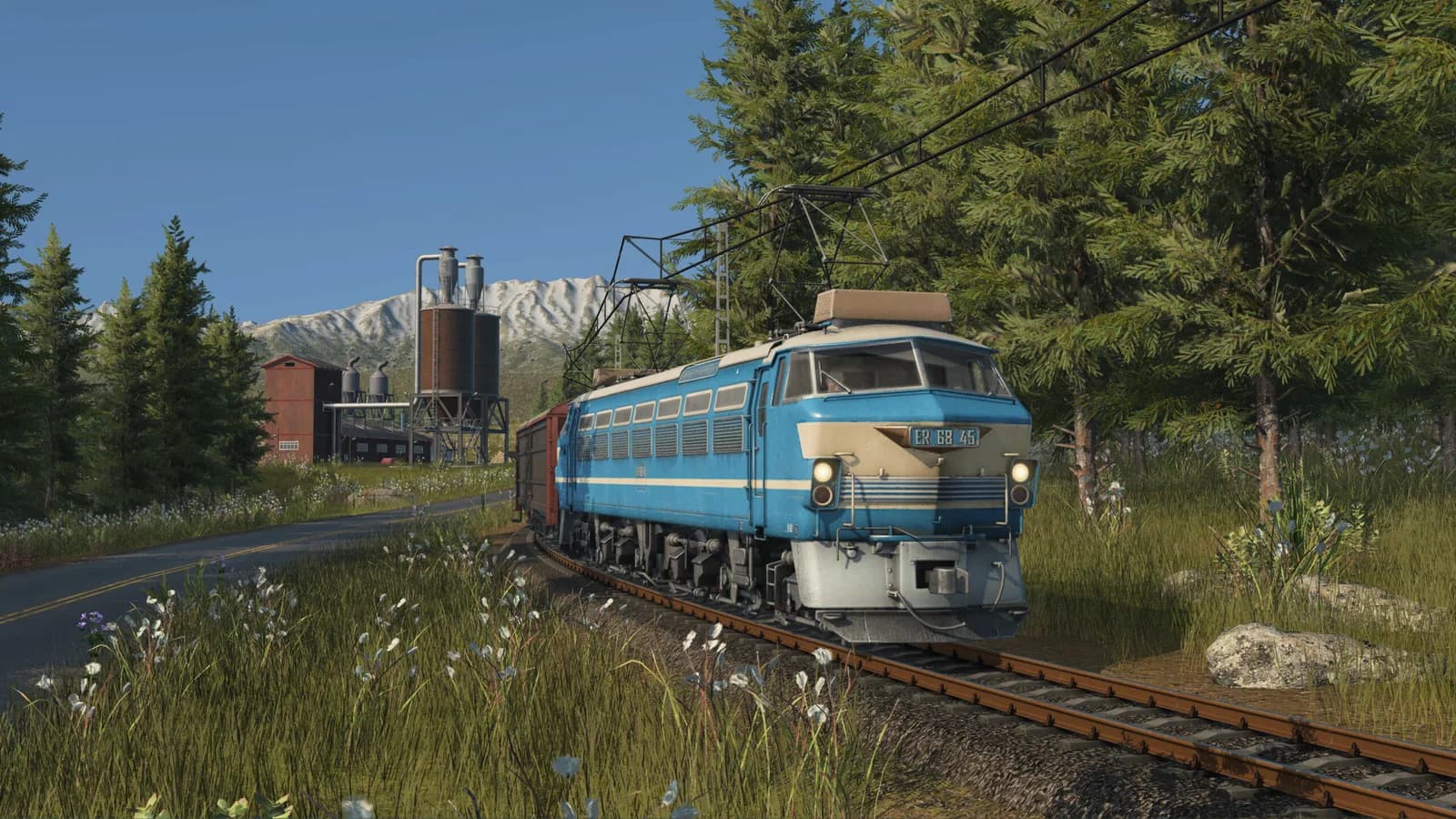 Blue locomotive in a wooded landscape